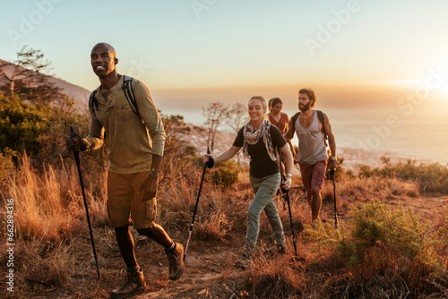 Diverse group of young people hiking in the mountains photo