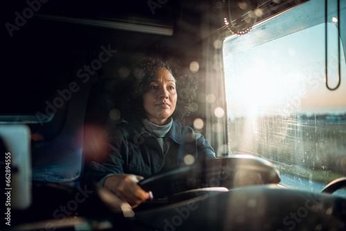 Middle aged female truck driver on the road