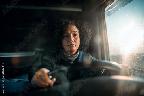 Middle aged female truck driver on the road photo