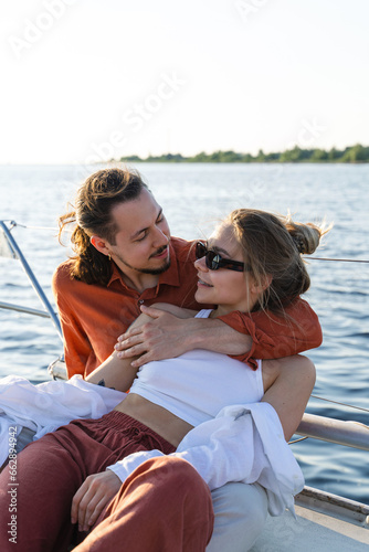 Young attractive couple relaxing on the sailboat during sailing in the sea © blackday