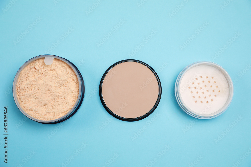 Three different face powders on light blue background, flat lay Three different face powders on light blue background, flat lay