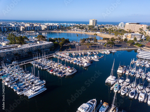 Aerial drone views of the marina in Marina Del Rey, California in the morning light. Views of docked boats, marina beach, marina towers, venice and marina del Rey neighborhoods, the beach, and Los Ang © Adam