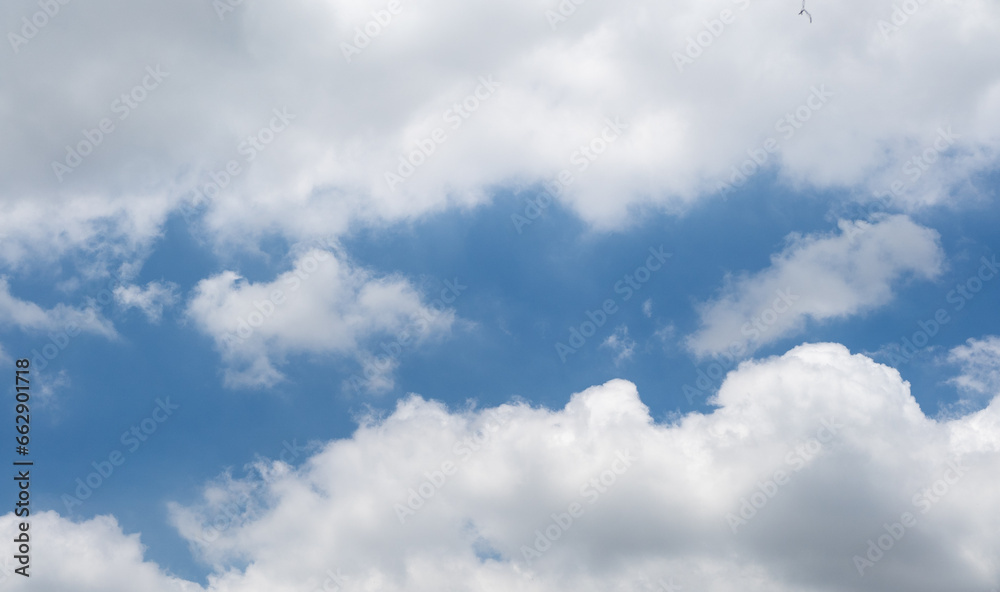 Blue sky background with white clouds. The vast blue sky and clouds sky on sunny day. White fluffy clouds in the blue sky. Blue sky background with white clouds. The vast blue sky and clouds sky on sunny day. White fluffy clouds in the blue sky.