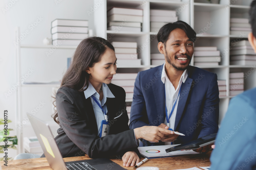 Group of young Asian business people talk, consult, discuss working with new startup project idea presentation analyze plan marketing and investment. Group of young Asian business people talk, consult, discuss working with new startup project idea presentation analyze plan marketing and investment.
