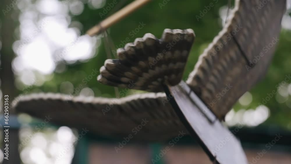 A wooden figure of a bird moves and flaps its wings with the help of strings. Funny toy A wooden figure of a bird moves and flaps its wings with the help of strings. Funny toy