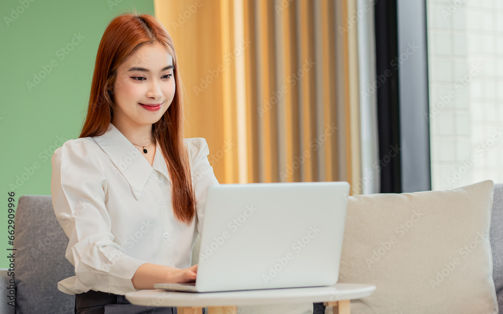 Beautiful Asian business woman sitting in modern office, using laptop for planning tasks or works, smiling, Entrepreneur, Business Owner Concept. Beautiful Asian business woman sitting in modern office, using laptop for planning tasks or works, smiling, Entrepreneur, Business Owner Concept.