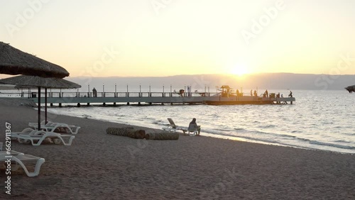 Umbrella on the beautiful beach. Tropical resort in Tala Bay, Hashemite Kingdom of Jordan. Red sea, gulf of Aqaba. View on Israel and Egypt on the other coast
