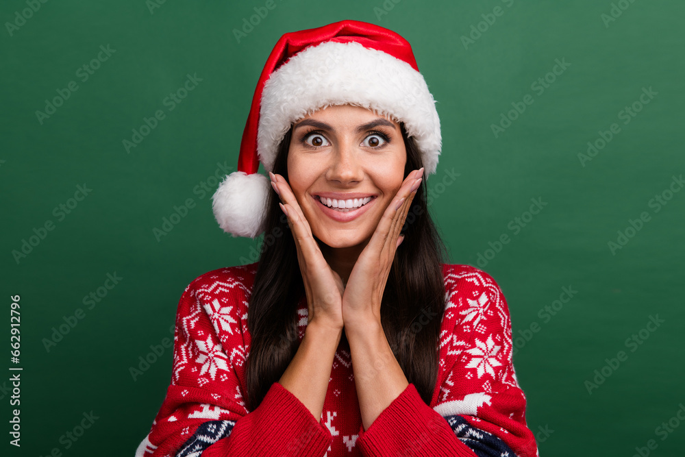 Photo of impressed cute cheerful person beaming smile arms touch cheeks isolated on green color background Photo of impressed cute cheerful person beaming smile arms touch cheeks isolated on green color background