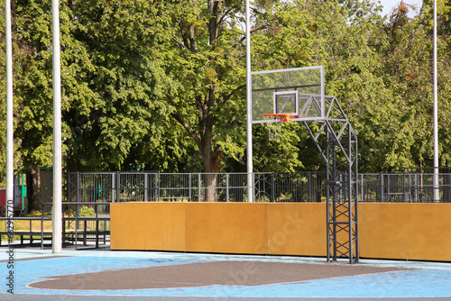 Empty basketball court with backboard outdoors on sunny day