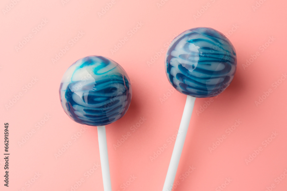 Tasty lollipops on pink background, flat lay Tasty lollipops on pink background, flat lay