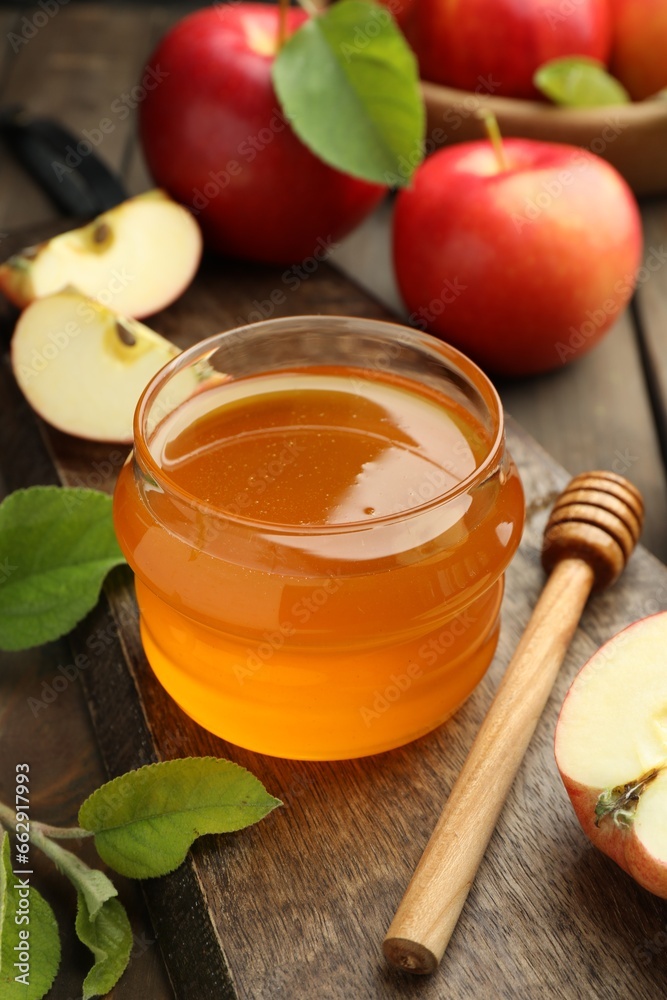 Sweet honey and fresh apples on wooden table