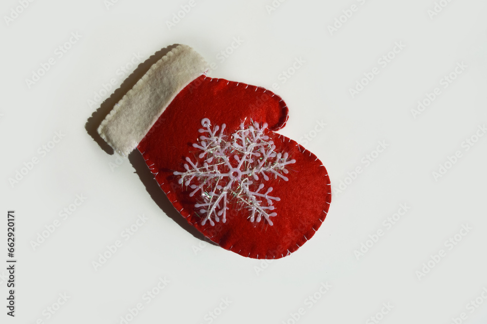 background for the design of the winter holidays of Christmas and New Year. decorative festive mitten with a snowflake. home decorations. background for the design of the winter holidays of Christmas and New Year. decorative festive mitten with a snowflake. home decorations.