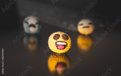 hidden emotions concept represented with crocheted emoticon amigurumis photo