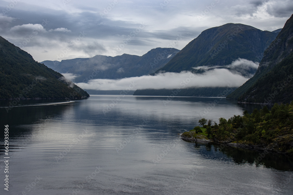 Spectacular Geiranger Fjord with low clouds between mountains, Norway