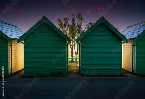 Beach hut chalets and morning light at Langland Bay on the Gower Peninsula in Swansea, South Wales UK
 photo