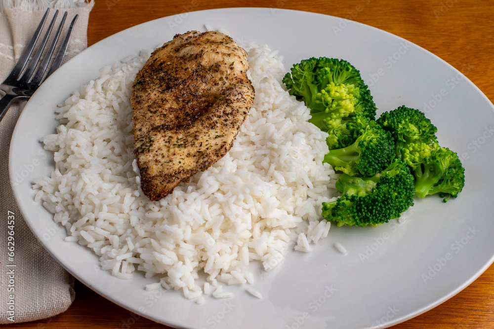 chicken breast and rice served with broccoli chicken breast and rice served with broccoli
