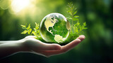 Hand hold and protect the world with a green leaves around as symbol for sustainable developmen and responsible environmental and energy sources for renewable