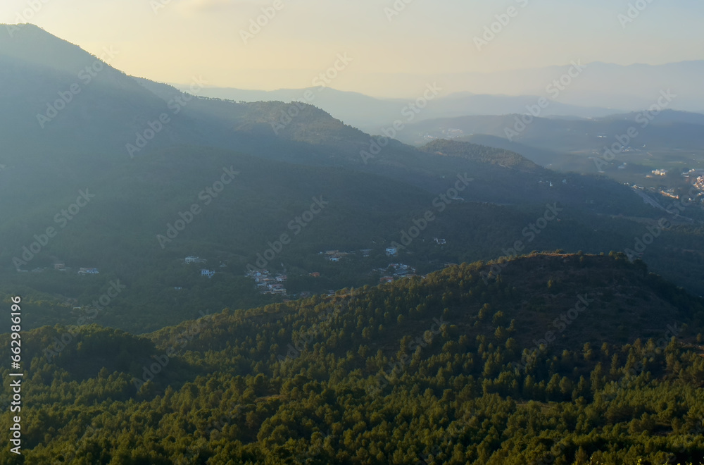 Mountains landscape, nature scenery. Sunset over mountain rock. View from Peak of La Redona mountain range in Sierra Calderona, Spain. Landscape of a mountain valley.