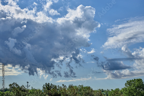 clouds in the blue sky in summer over the black sea beach © justoomm