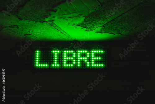 illuminated green traffic sign for free parking in indoor parking