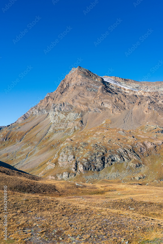 Basei rocky mountain and glacier on the top, Gran Paradiso National Park. view from Nivolet trail in autumn. blue sky (copy space) with no clouds