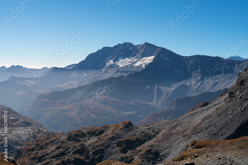 landscape of Levanne mountains in Gran Paradiso National Park, blue sky and Orco Valley with haze