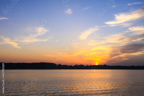 Peaceful landscape with lake in autumn sunset light in Latvia.