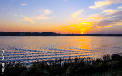 Peaceful landscape with lake in autumn sunset light in Latvia. © pictures_for_you