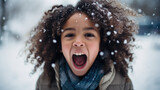 Winter portrait of kid with open mouth in snow.