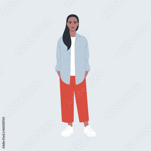 Stylishly dressed girl in full length on a gray background