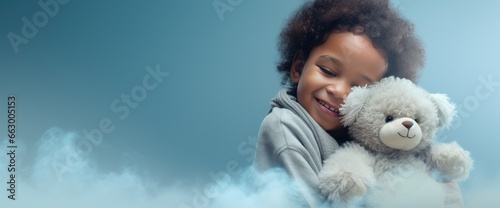 a child hugging a white teddy bear with love, on a blue background, including copy space for text