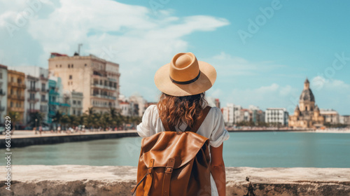 Tourist Woman with Hat and Backpack in XXX. Wanderlust concept.