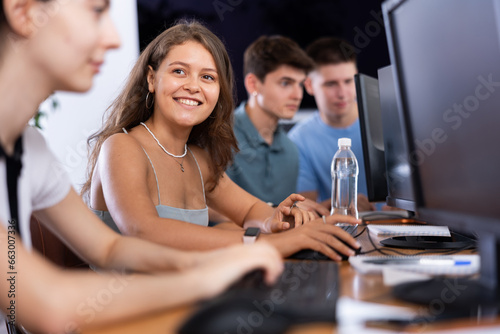 In classroom, young female student is engrossed in her computer based tasks.