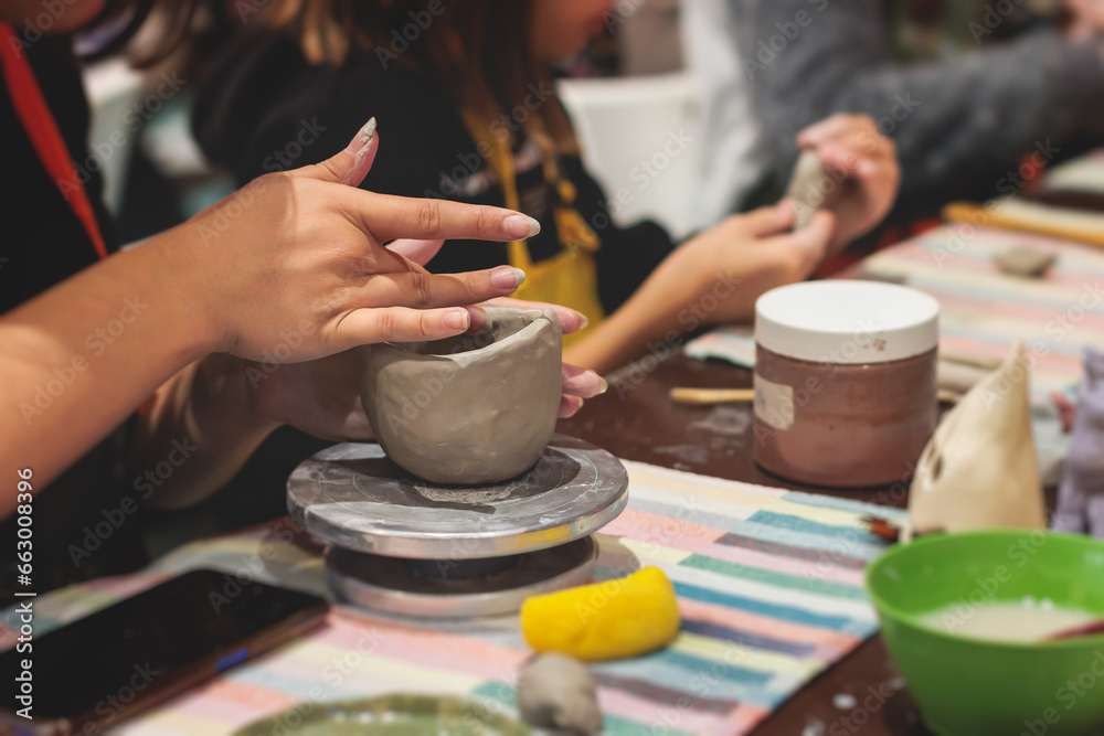 Pottery lesson master class for kids children, process of making clay pot on pottery wheel, potter hands creating ceramic crockery handcrafts, ceramist molding and painting jar or vase