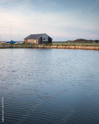 A fisherman's hut by a calm lake