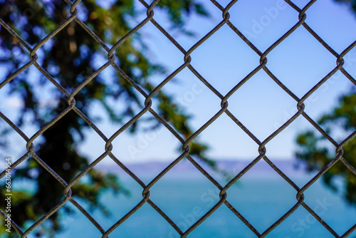 View through a chain link fence on the Alcatraz Island.