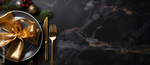 A festive banner with golden cutlery on a black stone table, versatile for Christmas, New Year, or any use, with copy space for text