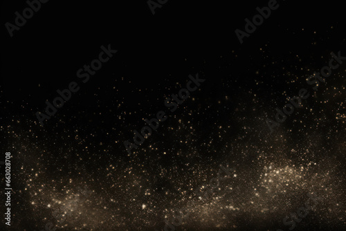 Gold glitter sparkles on the black background. Christmas festive background.