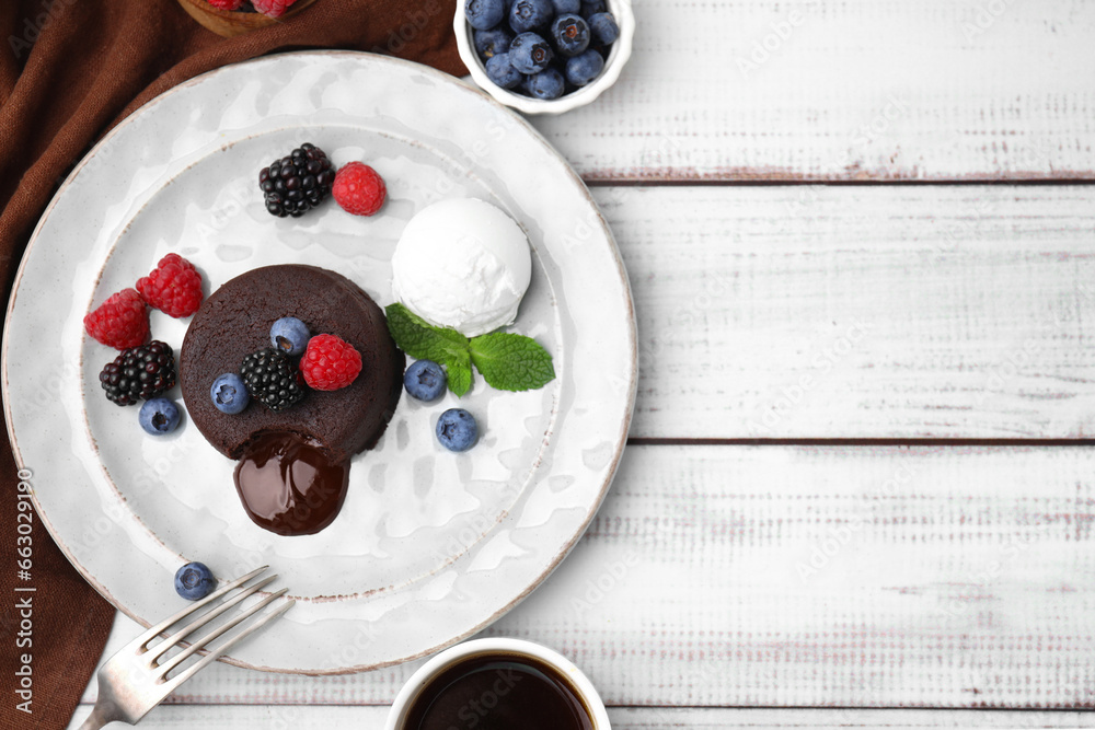 Fototapeta premium Delicious chocolate fondant served with fresh berries and ice cream on white wooden table, flat lay. Space for text