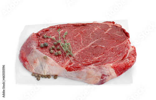 Piece of raw beef meat, peppercorns and thyme isolated on white