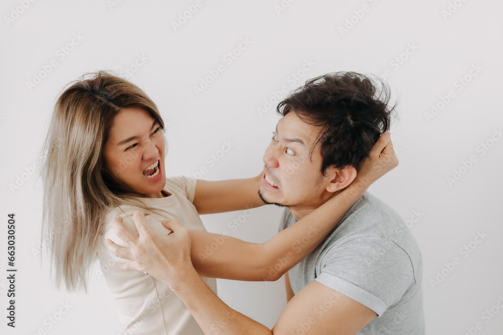 Funny angry face asian couple mad and fight at each other isolated on white. Funny angry face asian couple mad and fight at each other isolated on white.