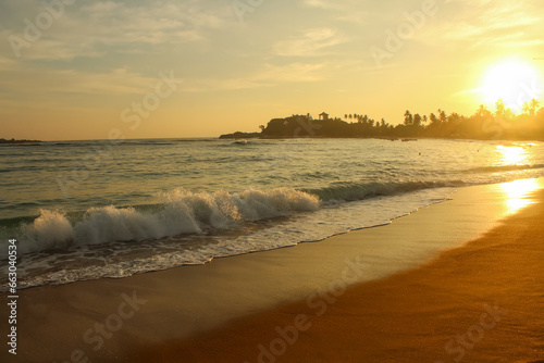 Beach with golden sand and blue ocean water on most popular Unawatuna