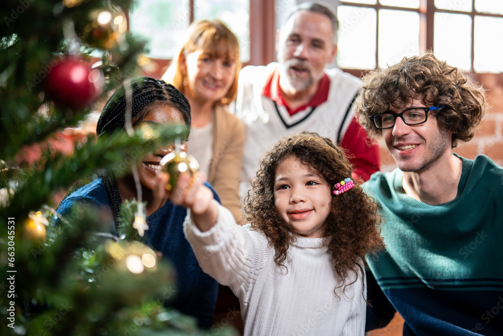 Multi-ethnic big family decorate Christmas tree in living room at home. Multi-ethnic big family decorate Christmas tree in living room at home.