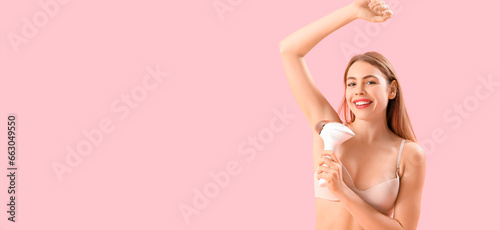 Pretty young woman with modern photoepilator on pink background with space for text © Pixel-Shot