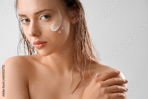 Sexy young woman with cream...