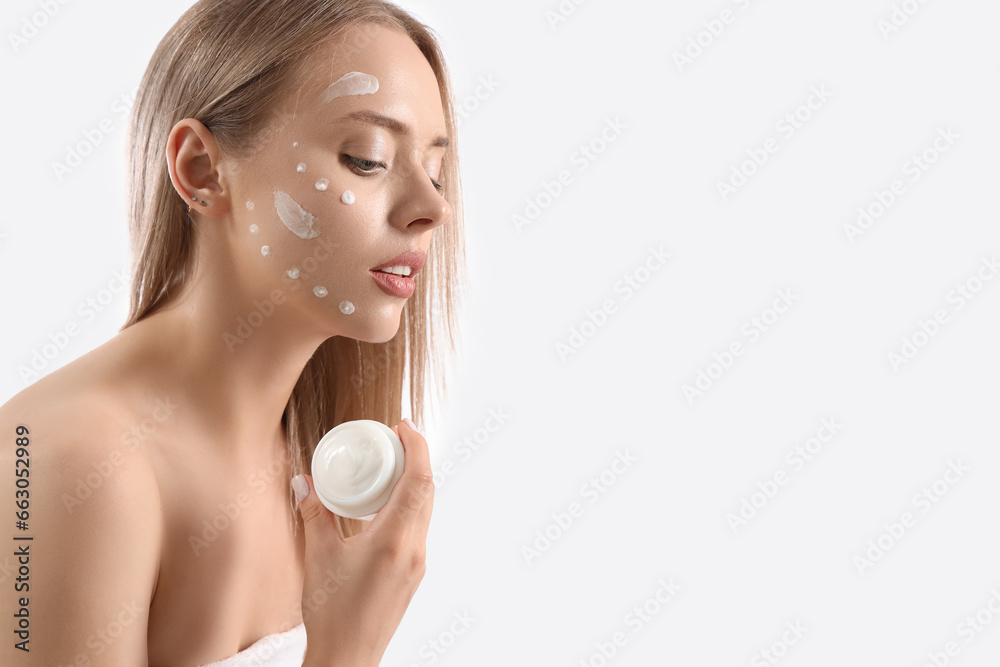 Sexy young woman with facial cream on white background Sexy young woman with facial cream on white background