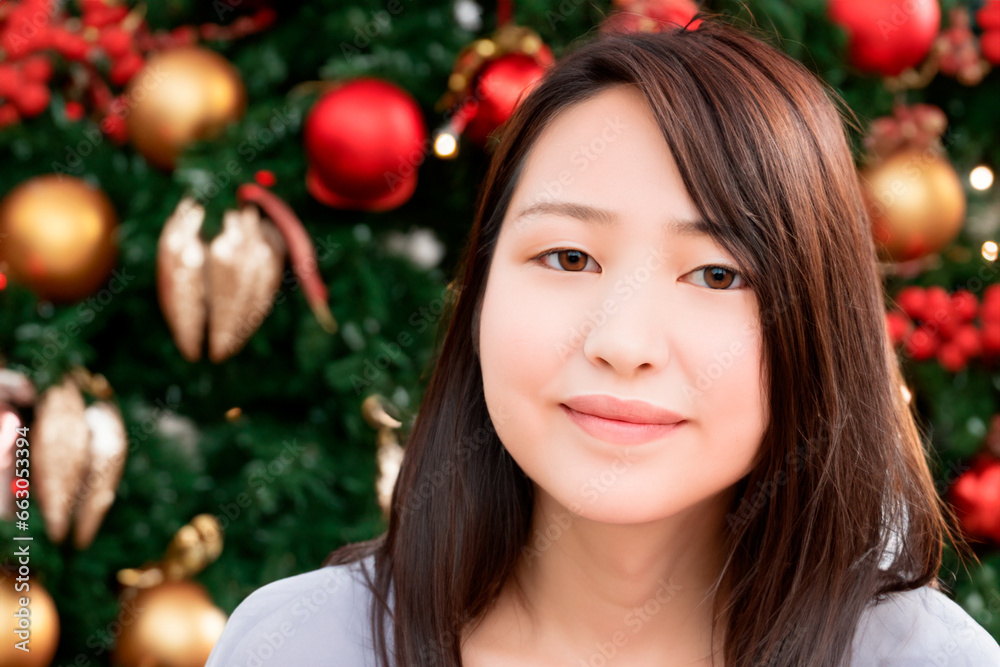 Christmas portrait of a Japanese woman in a white blouse with long hair