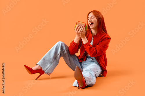 Young redhead woman with ta...