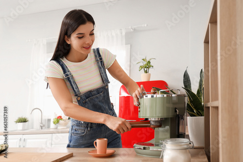 Young woman making coffee i...