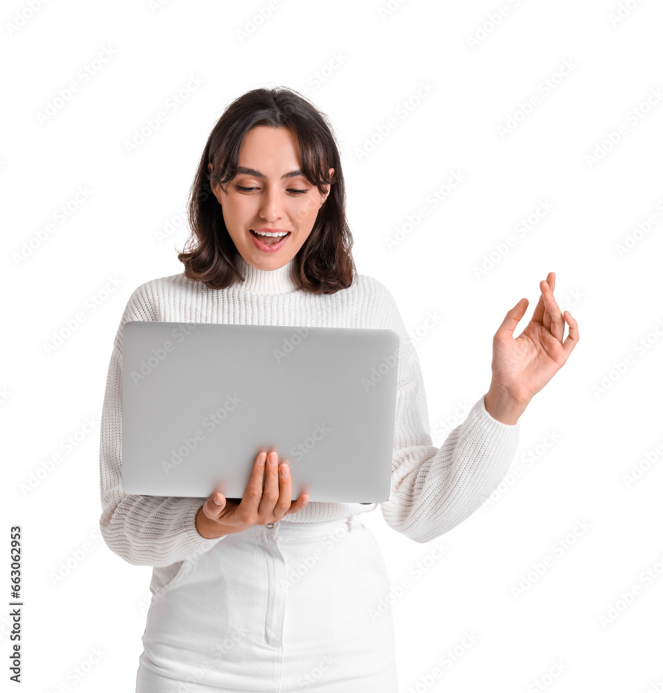Young woman in warm sweater with laptop on white background Young woman in warm sweater with laptop on white background